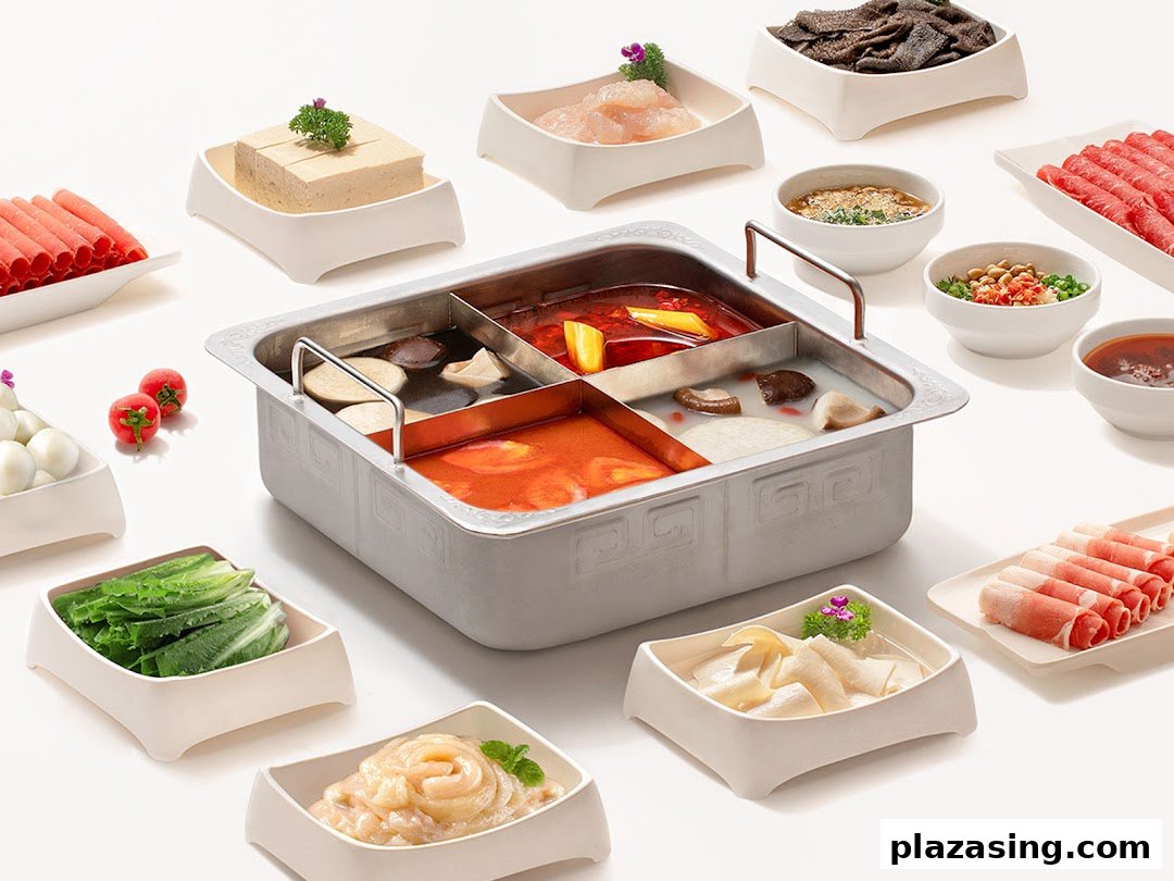 A vibrant hot pot spread featuring a multi-compartment pot and various fresh ingredients.