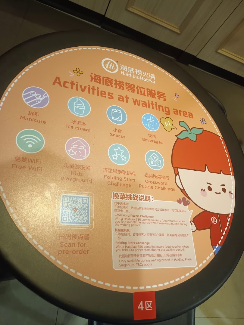 A sign at Haidilao Hot Pot detailing various activities and challenges available in the waiting area.