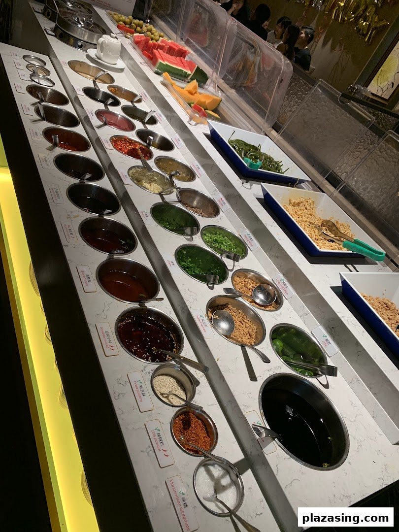 A vibrant self-service bar featuring a wide array of sauces, condiments, and fresh fruits.