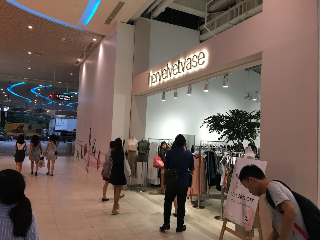 Customers browse stylish apparel and accessories inside the modern hervelvetvase boutique.
