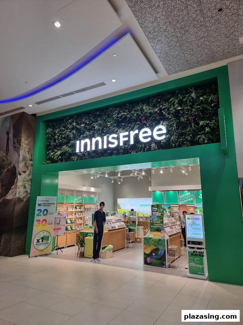 The vibrant green storefront of Innisfree, showcasing its natural aesthetic and inviting entrance.