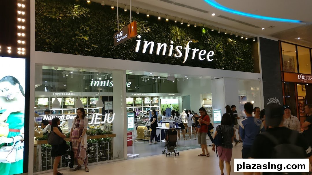 The innisfree shop front with a distinctive green wall, showcasing its natural beauty concept.