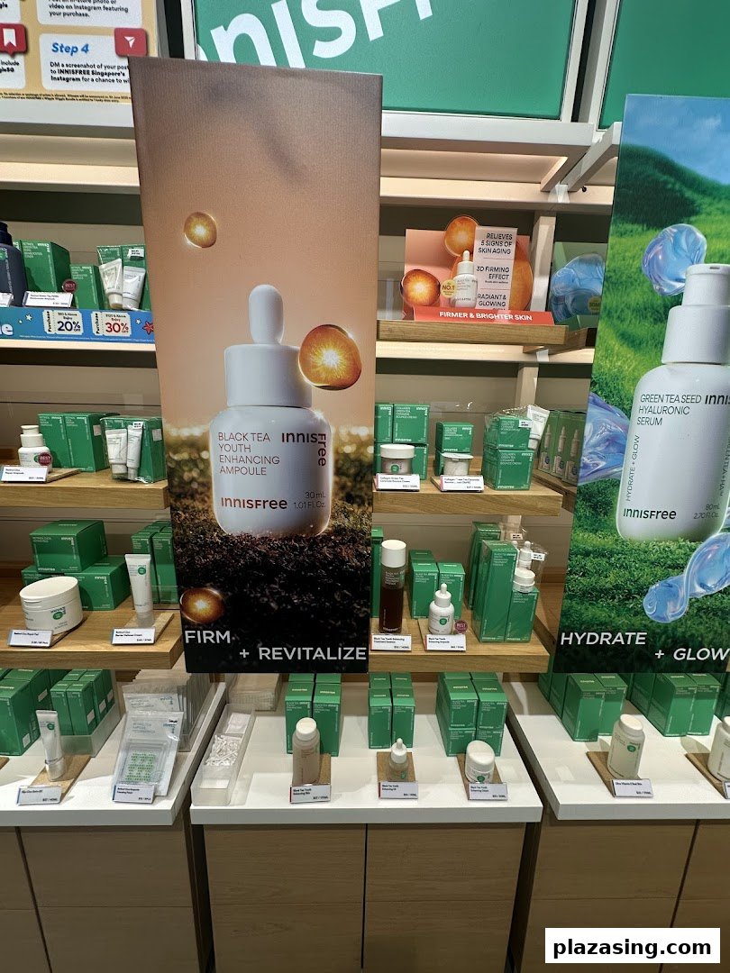 Innisfree skincare products, including ampoules and serums, displayed on shelves with promotional signage.