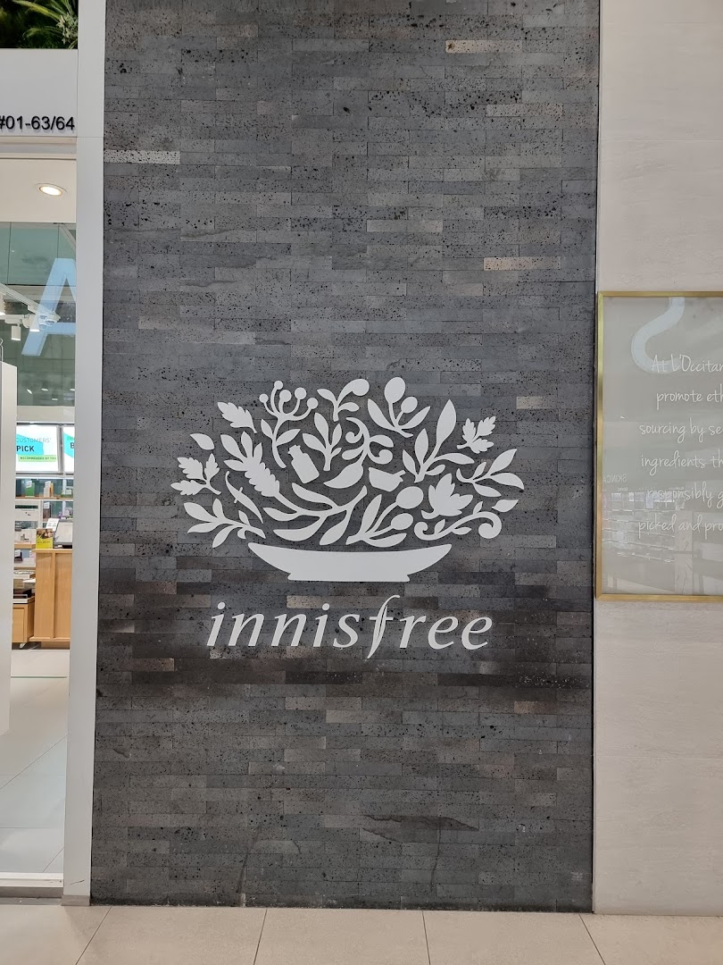 Innisfree shop front featuring its distinctive logo and name on a textured wall at Plaza Singapura.