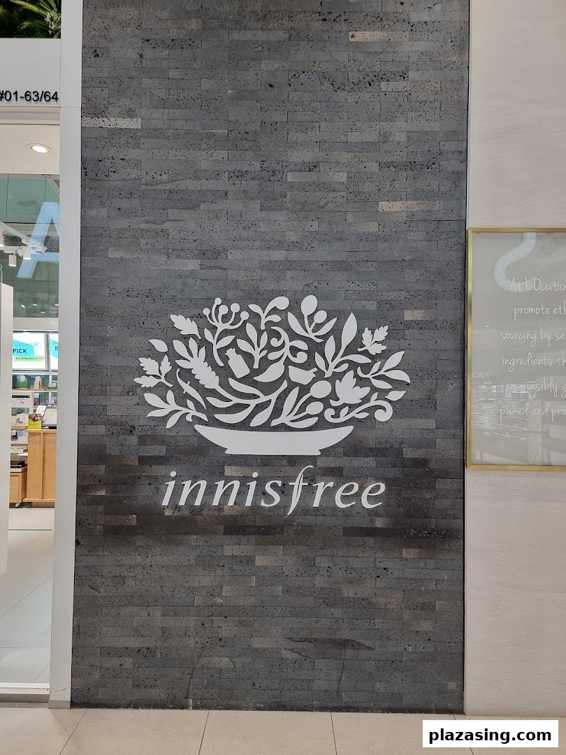 Innisfree shop front featuring its distinctive logo and name on a textured wall at Plaza Singapura.