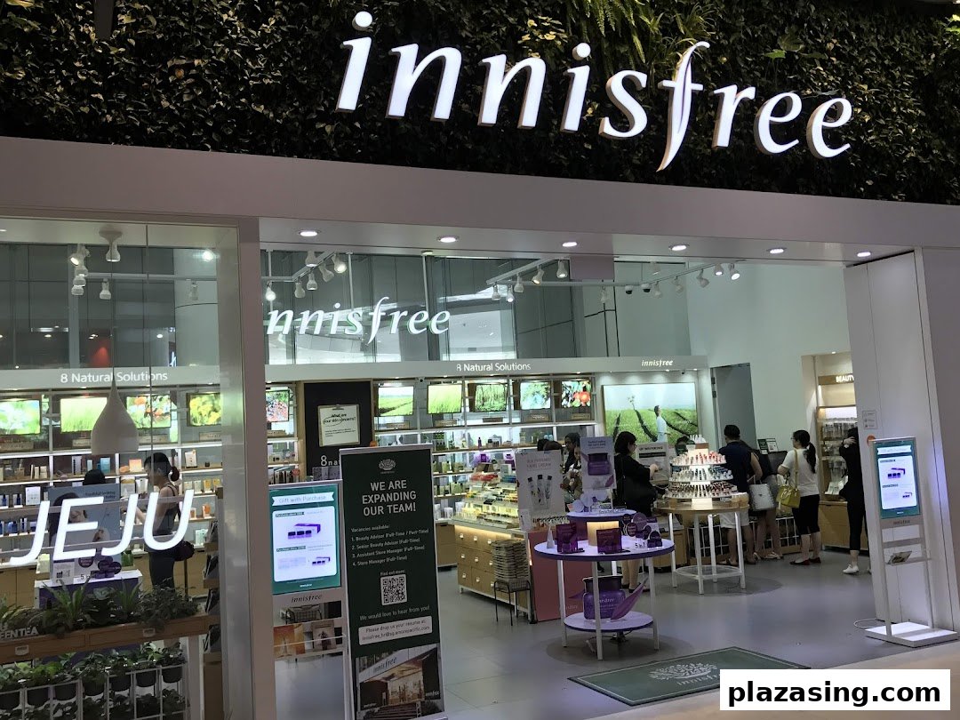 Brightly lit entrance of Innisfree beauty store, showcasing natural skincare products and inviting customers.