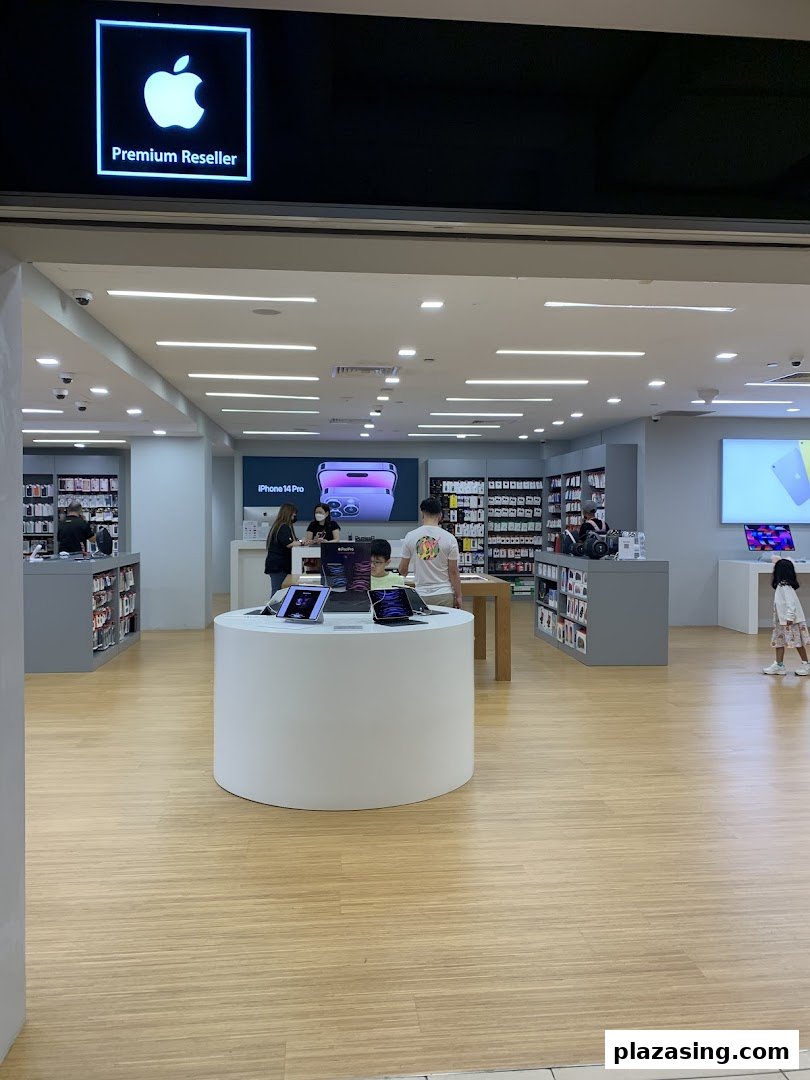 Entrance view of iStudio, an Apple Premium Reseller, showcasing various Apple products and customers browsing.