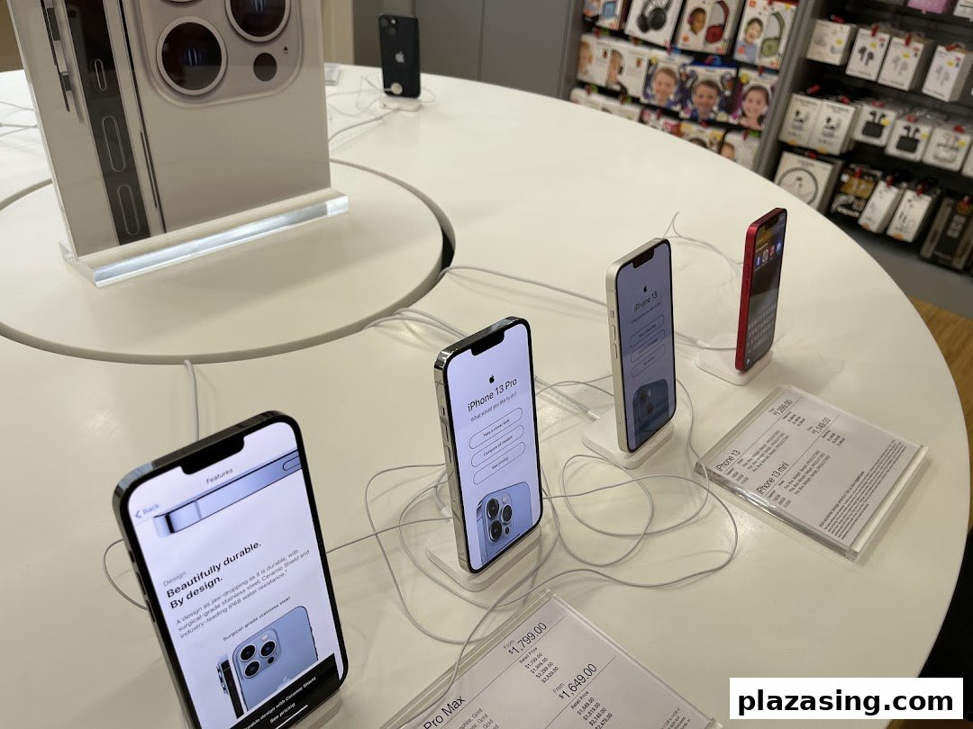 iPhones and accessories displayed on a circular table inside iStudio Plaza Singapura.