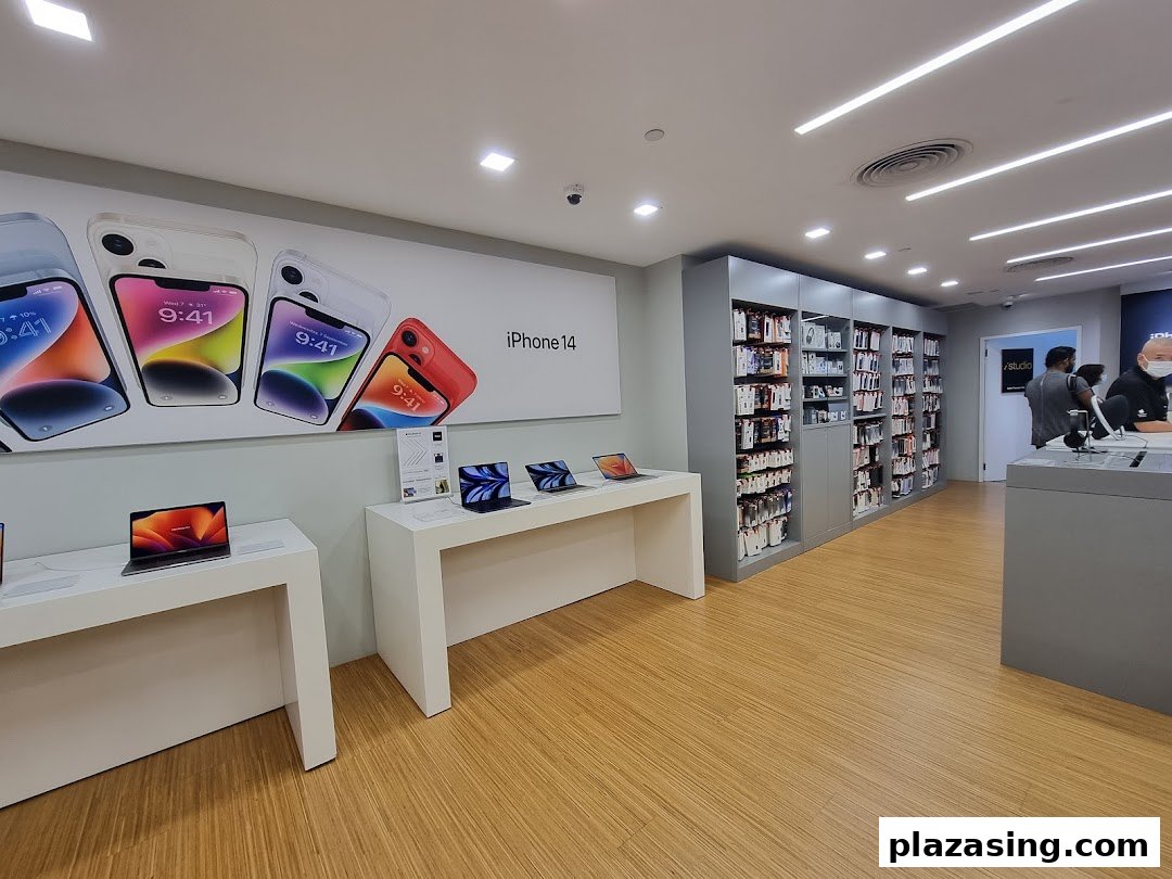 Interior view of iStudio showcasing Apple products like iPhones and MacBooks on display tables.