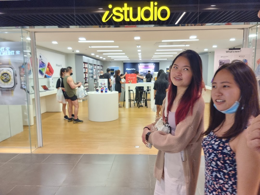 The iStudio shop entrance at Plaza Singapura, showcasing Apple products and inviting customers inside.