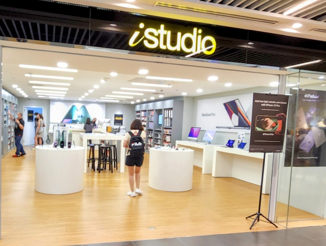 The iStudio shop front at Plaza Singapura, showcasing Apple products and a bright interior.