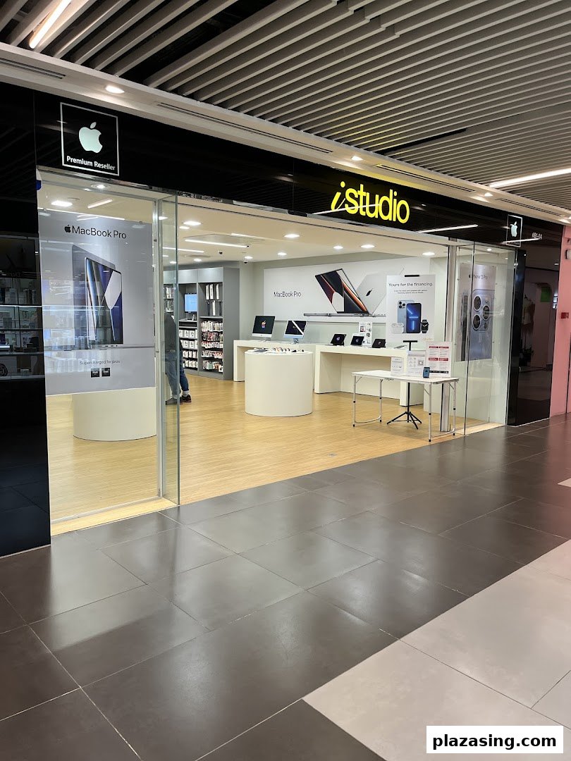 The storefront of iStudio, an Apple Premium Reseller, showcasing Apple products inside.