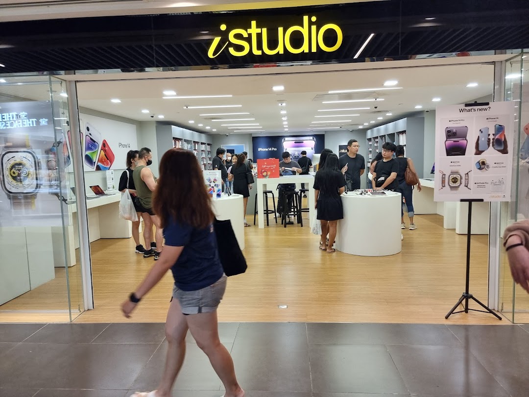 The iStudio shop entrance with customers browsing Apple products and displays inside.