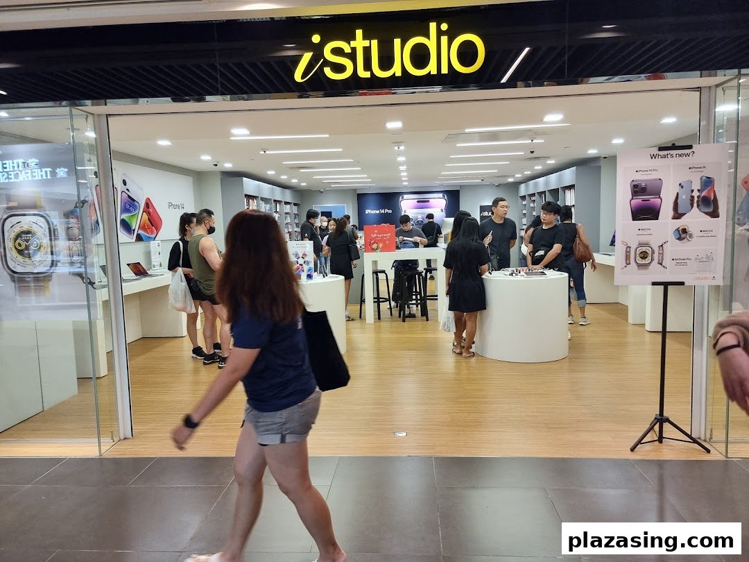 The iStudio shop entrance with customers browsing Apple products and displays inside.