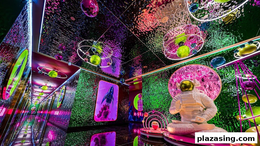 Vibrant, space-themed interior of K.STAR with an astronaut statue and neon lights.
