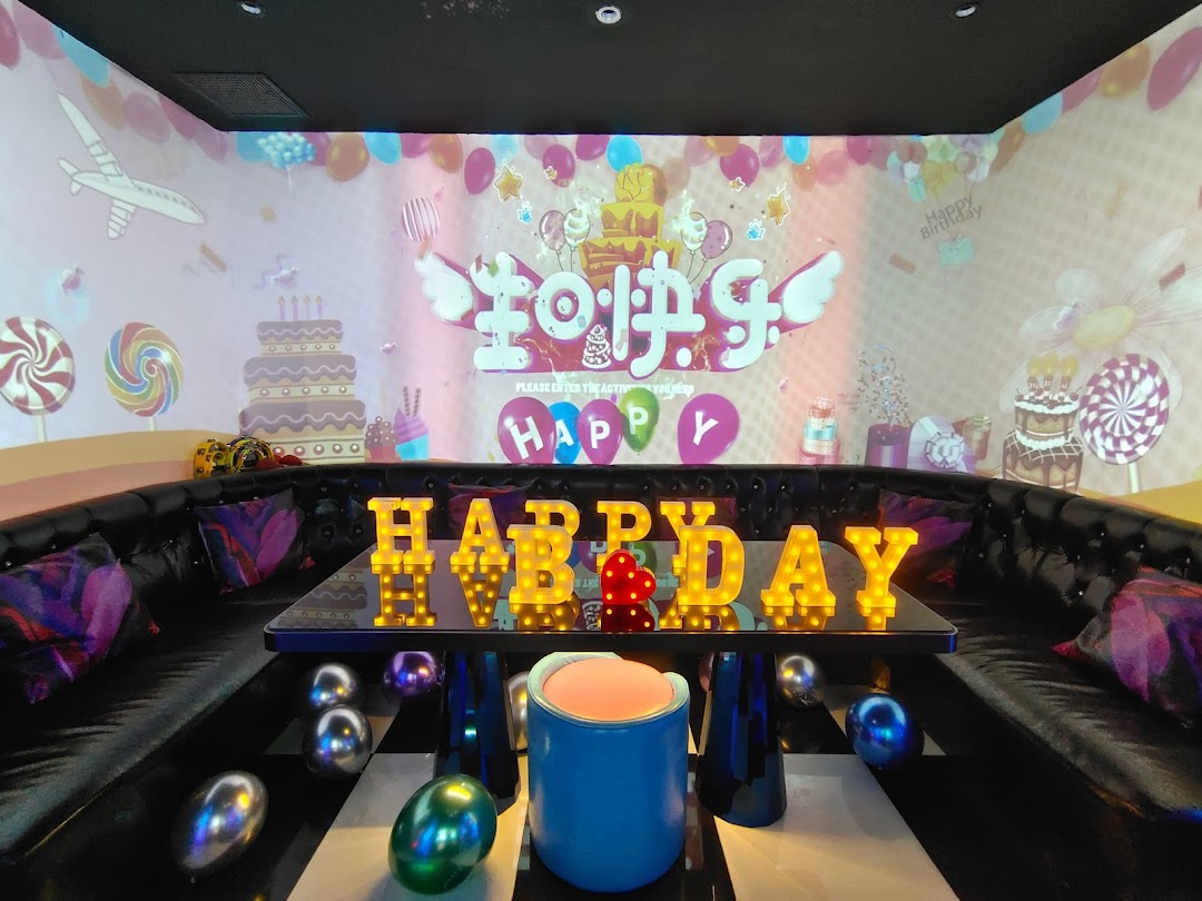 Vibrant KTV room at K.STAR with birthday decorations, large screen projection, and illuminated 'HAPPY B'DAY' sign.