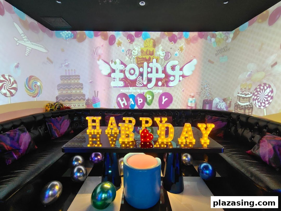 Vibrant KTV room at K.STAR with birthday decorations, large screen projection, and illuminated 'HAPPY B'DAY' sign.