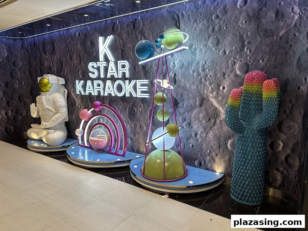 K.STAR Karaoke shop front featuring a space-themed wall, astronaut statue, and colorful decor.