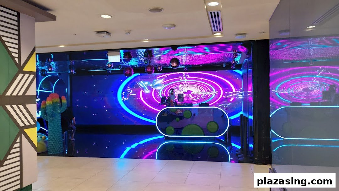 Vibrant, neon-lit entrance of K.STAR KTV with a large digital display and futuristic decor.