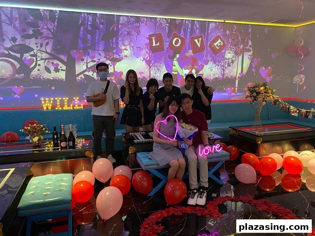 Friends celebrate a special occasion in a vibrant K.STAR KTV room with festive decorations.