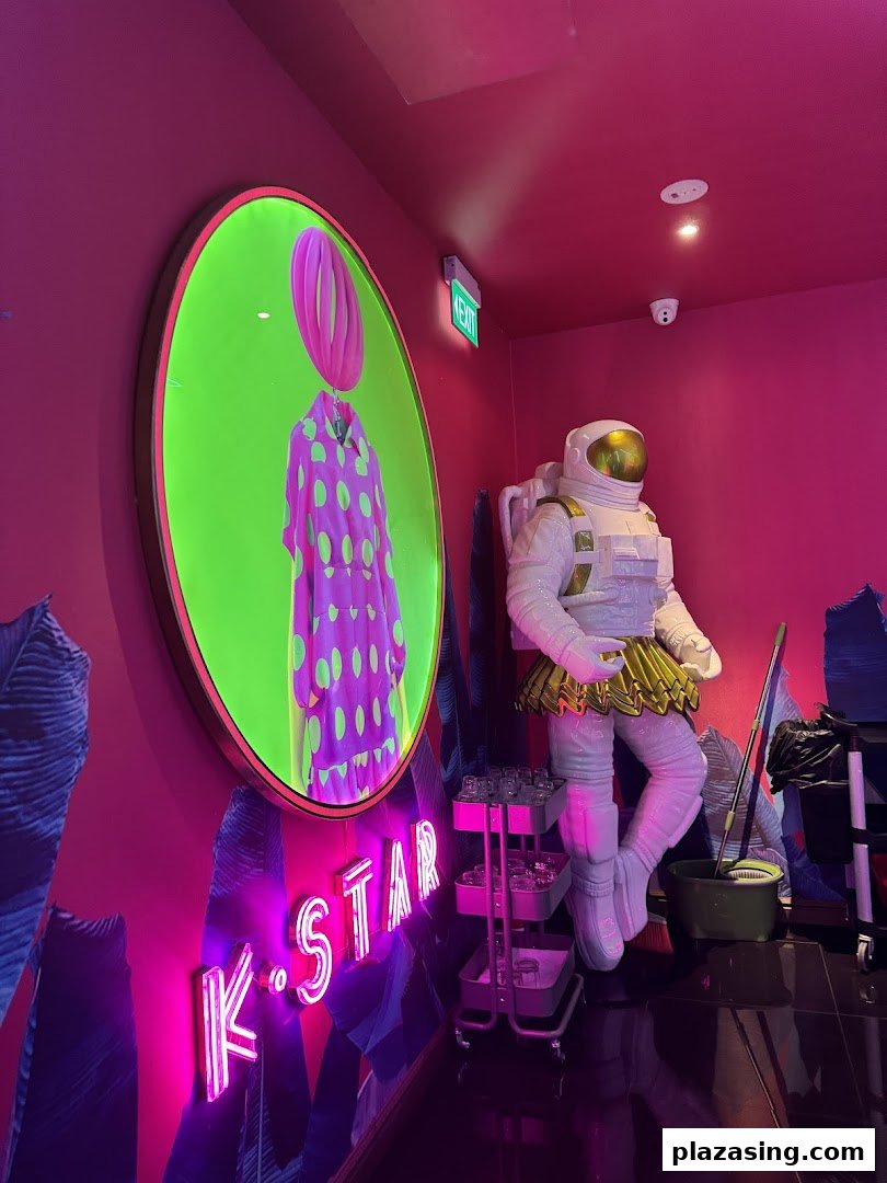 Vibrant, neon-lit interior of K.STAR featuring an astronaut statue and unique circular art.