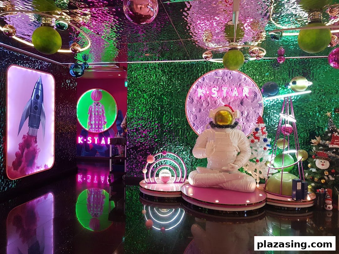 Vibrant, space-themed entrance display for K.STAR with an astronaut figure and neon lights.