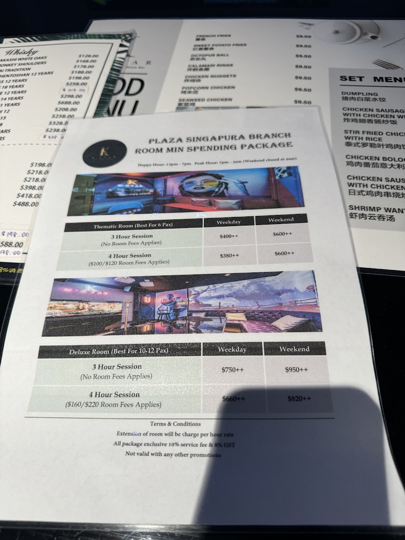 A menu displaying K.STAR's room spending packages, whisky, snacks, and set menu items.
