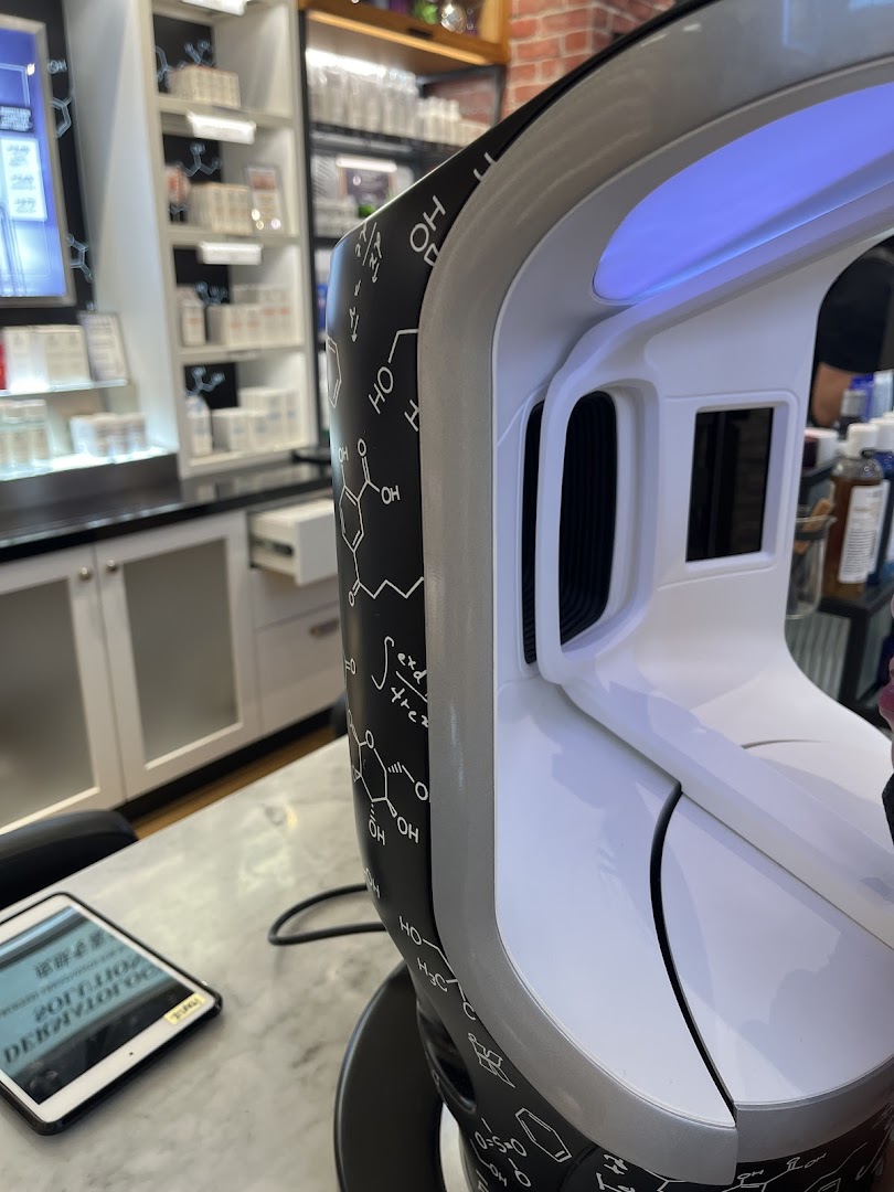 Close-up of a skin analysis device at Kiehl's, with product shelves visible in the background.