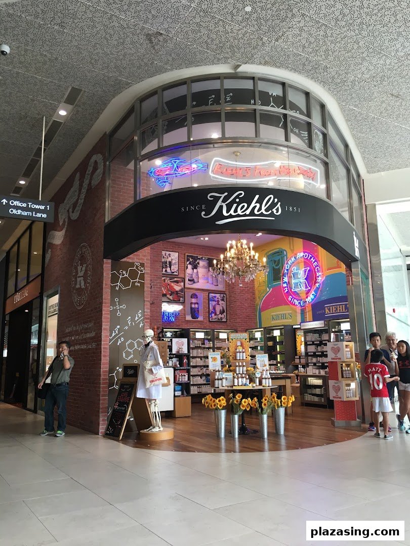 The inviting entrance of Kiehl's Plaza Singapura, showcasing its signature skincare products and unique decor.