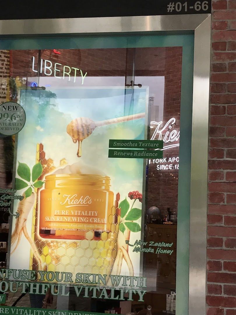 Kiehl's shop window featuring a large promotional poster for Pure Vitality Skin Renewing Cream.