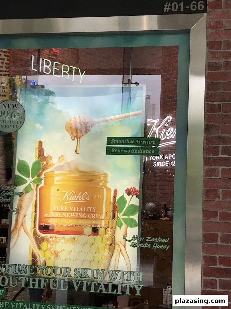 Kiehl's shop window featuring a large promotional poster for Pure Vitality Skin Renewing Cream.