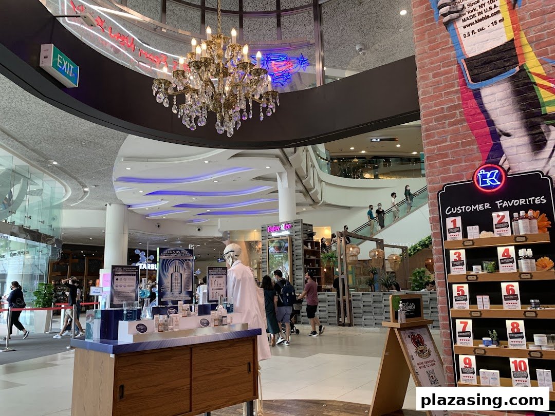 A Kiehl's product display featuring skincare and customer favorites in a brightly lit shopping mall common area.