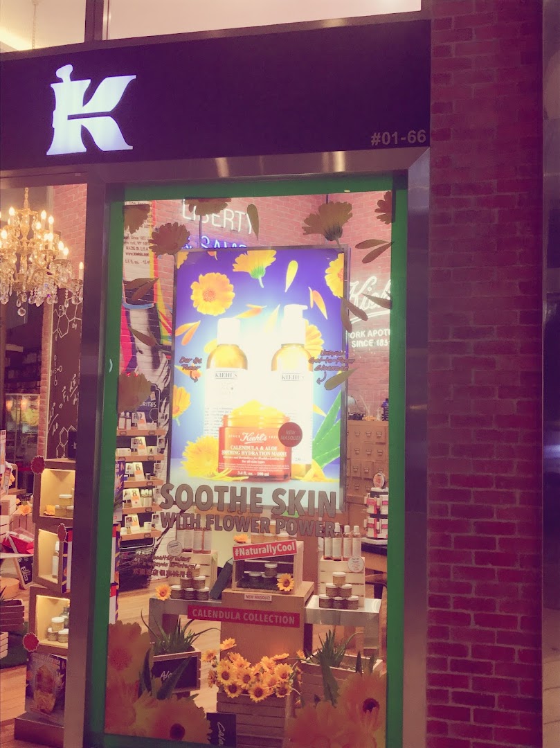 The shop front of Kiehl's featuring a vibrant display of calendula skincare products.