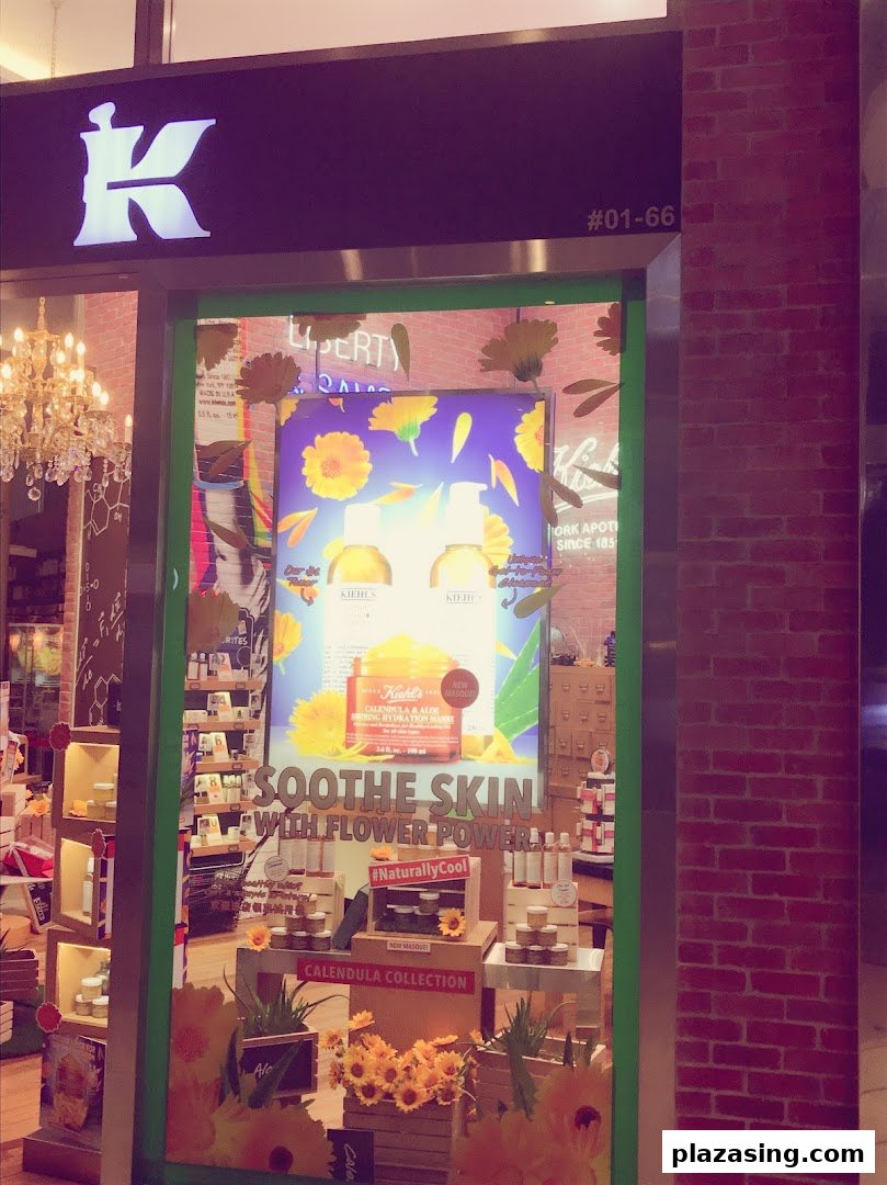 The shop front of Kiehl's featuring a vibrant display of calendula skincare products.
