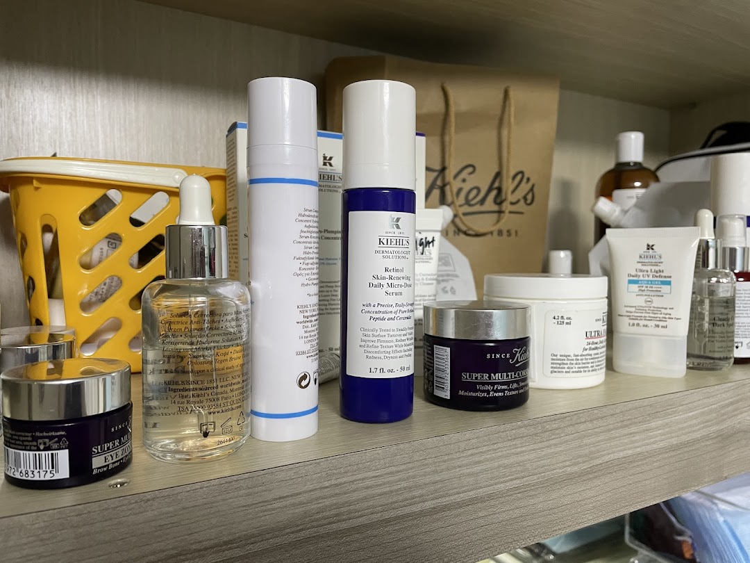 A close-up of a shelf showcasing a variety of Kiehl's skincare products, including serums, moisturizers, and eye creams.