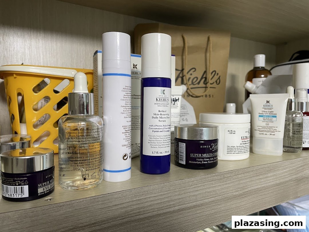 A close-up of a shelf showcasing a variety of Kiehl's skincare products, including serums, moisturizers, and eye creams.