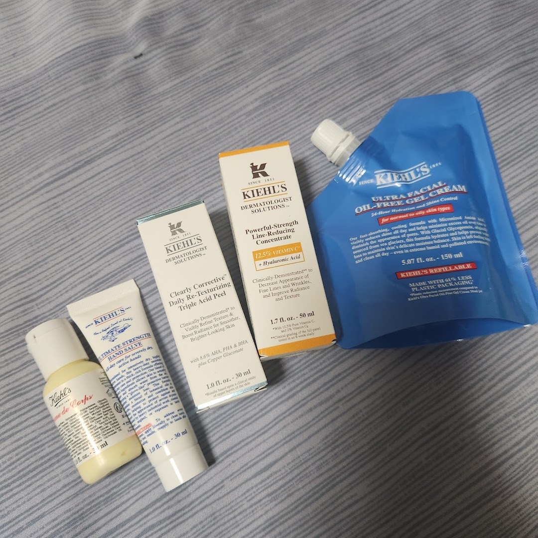 A collection of Kiehl's skincare products, including serums, hand salve, and a refillable gel cream.