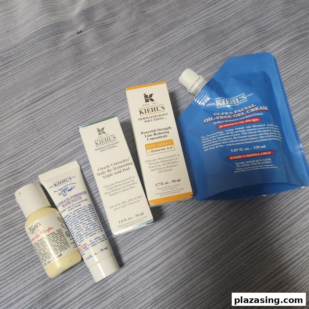 A collection of Kiehl's skincare products, including serums, hand salve, and a refillable gel cream.