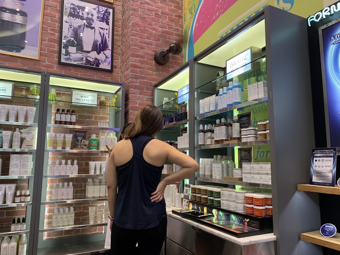 A customer browses skincare and body treatment products inside a Kiehl's store.