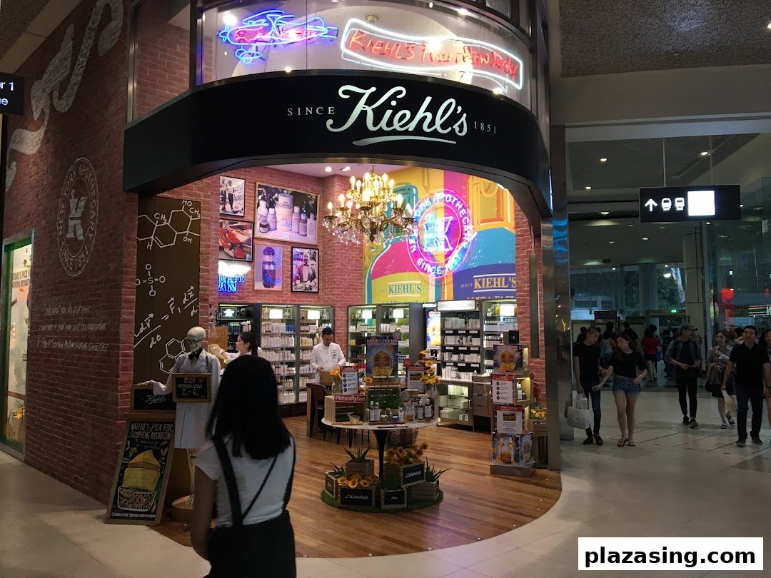 A vibrant Kiehl's store interior showcasing skincare products, a chandelier, and a unique apothecary aesthetic.