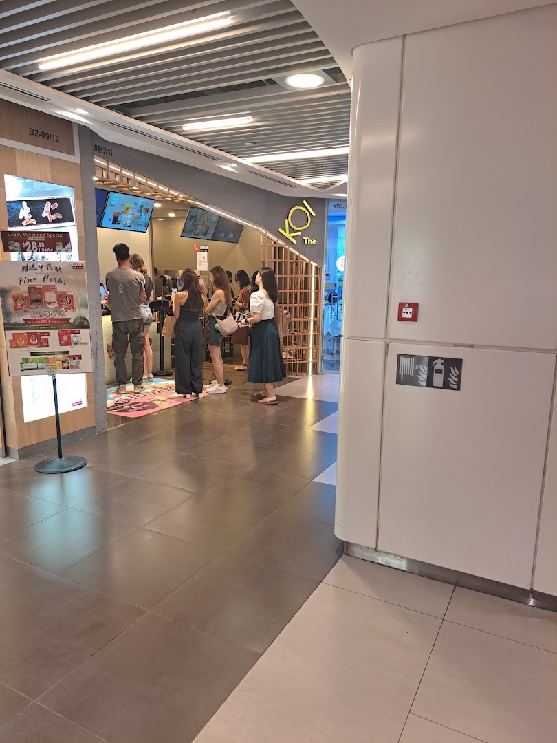 Customers queueing at the bustling entrance of KOI Thé bubble tea shop.