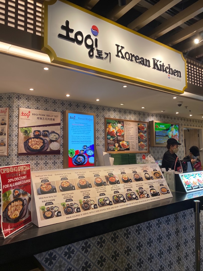 A vibrant counter at Togi Korean Kitchen, showcasing diverse menu options and a welcoming atmosphere.