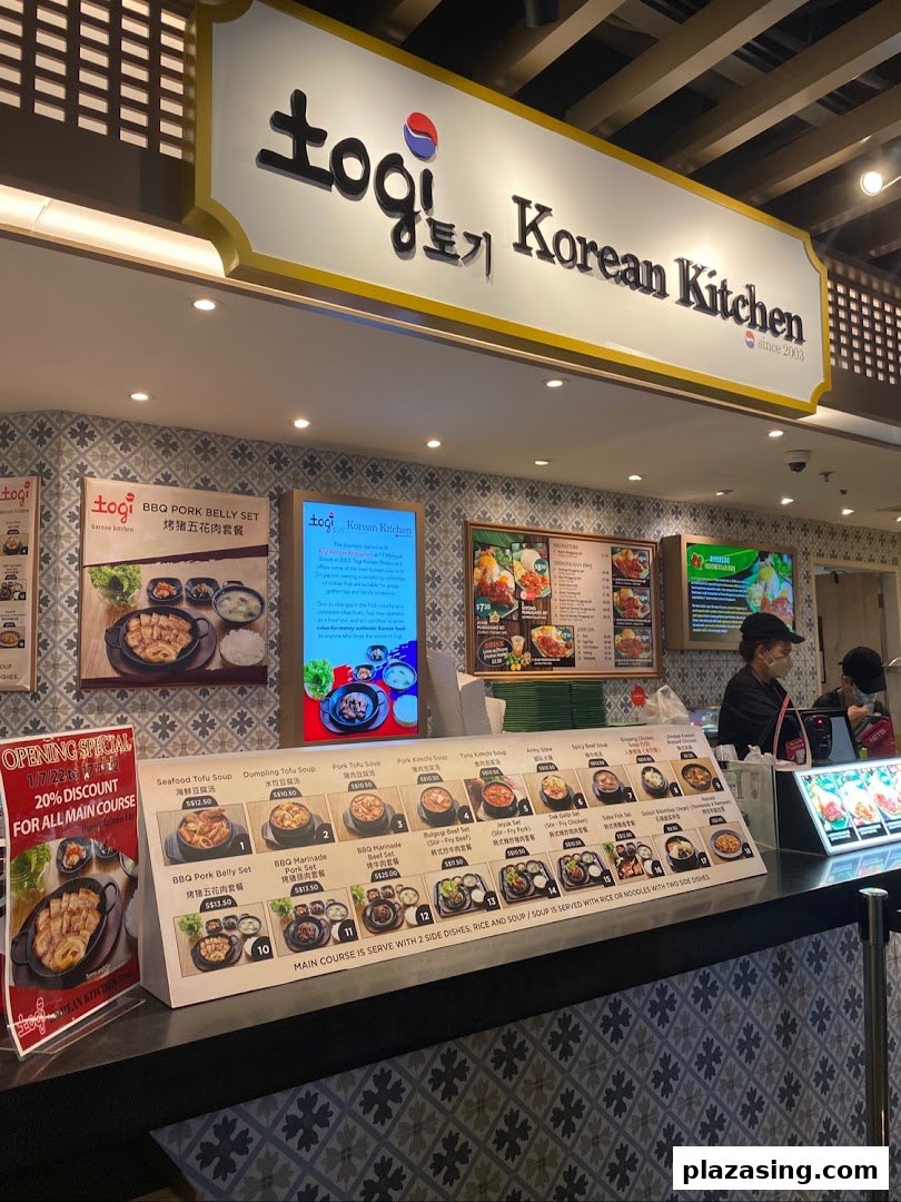 A vibrant counter at Togi Korean Kitchen, showcasing diverse menu options and a welcoming atmosphere.