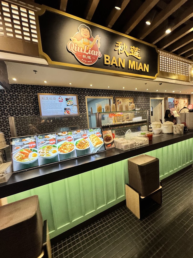 Interior view of Qin Lian Ban Mian stall, showcasing its counter, signage, and tempting food displays.