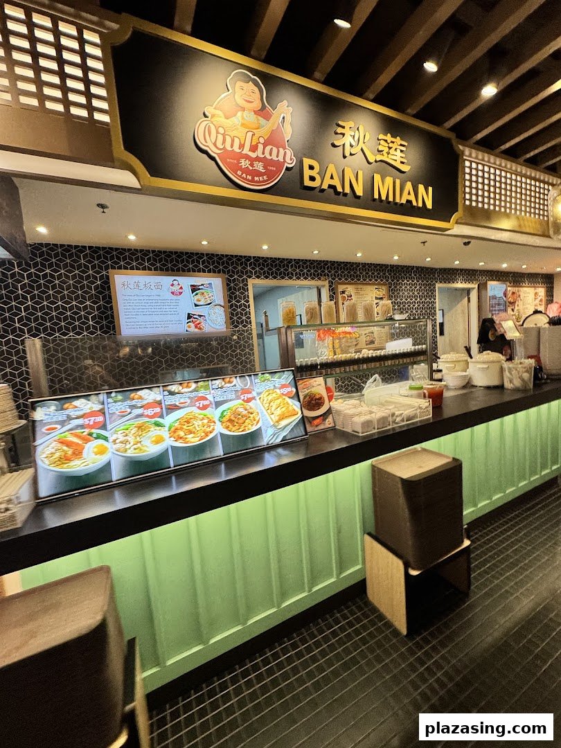 Interior view of Qin Lian Ban Mian stall, showcasing its counter, signage, and tempting food displays.