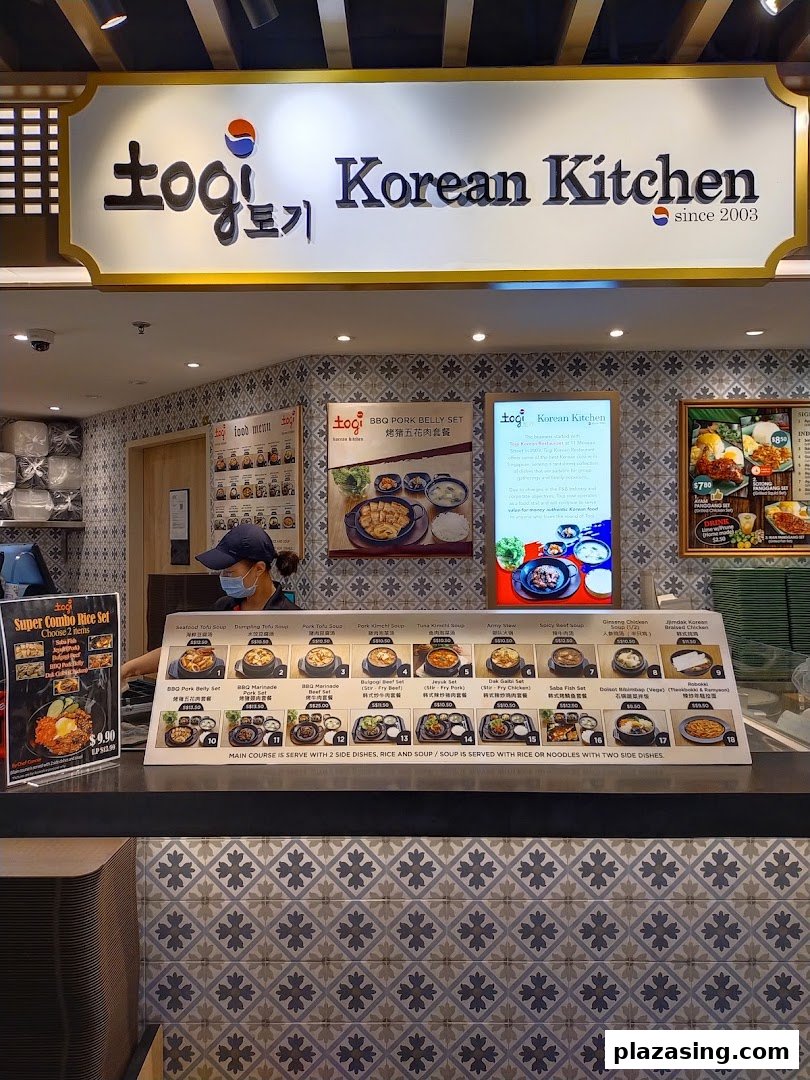 A counter view of Togi Korean Kitchen showcasing various Korean dishes and menu options.
