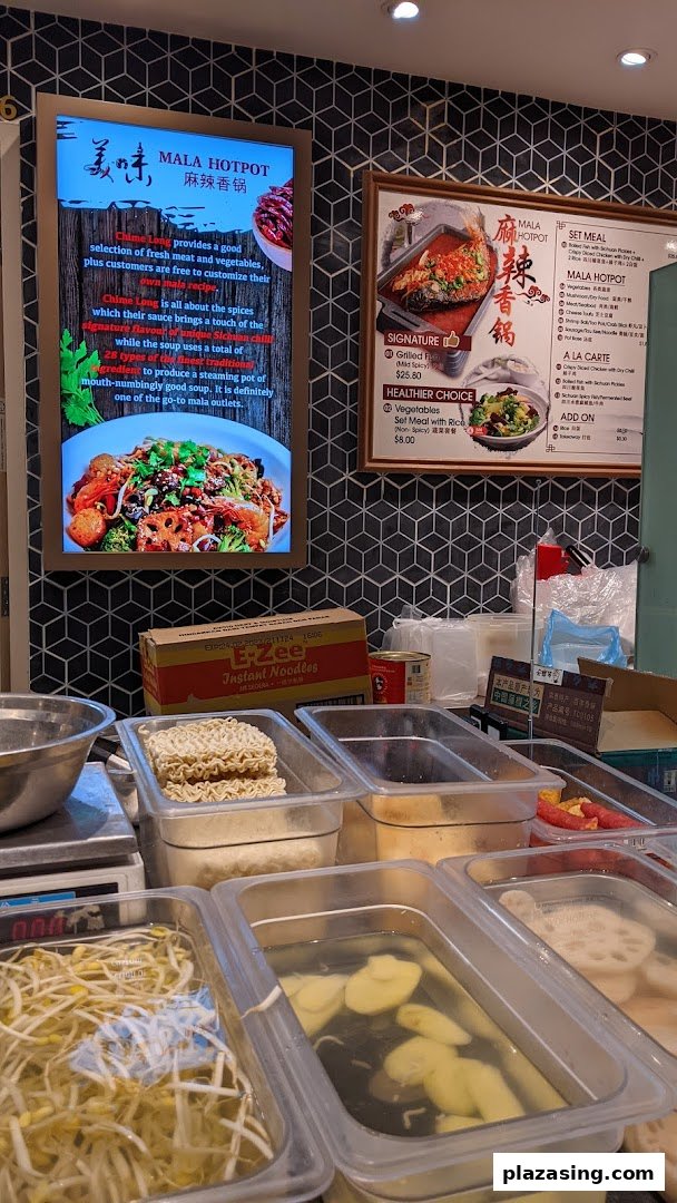 A vibrant Mala Hotpot counter showcasing fresh ingredients and detailed menu boards.
