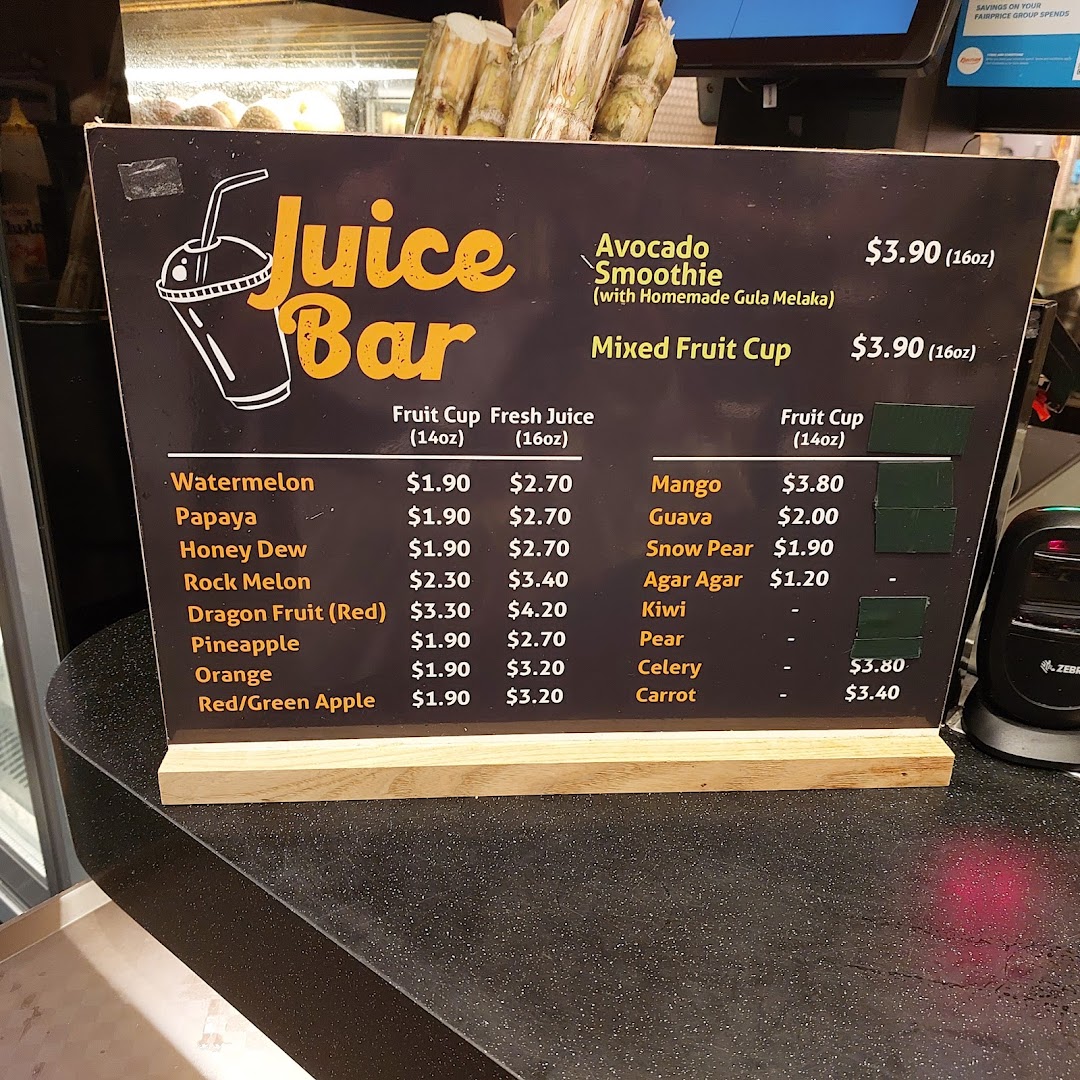 A menu board displaying various fresh juices and fruit cups with prices at Kopitiam Food Hall.