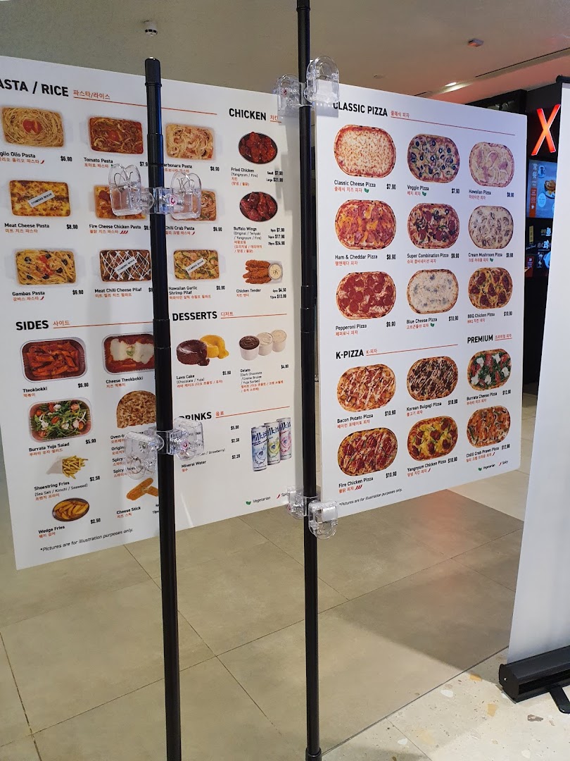 A detailed menu board displaying various pasta, chicken, pizza, sides, desserts, and drinks with prices.