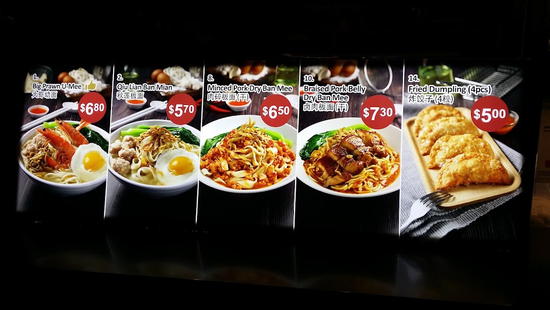 A vibrant menu display showcasing various noodle dishes and fried dumplings with prices.